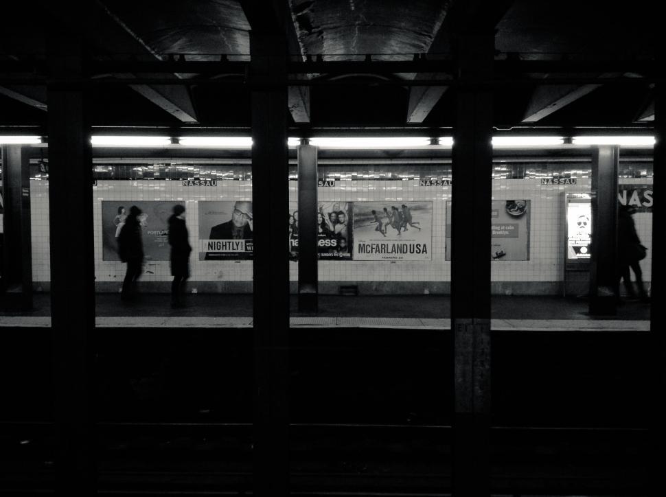 Free Image of Subway station platform with silhouetted figures 