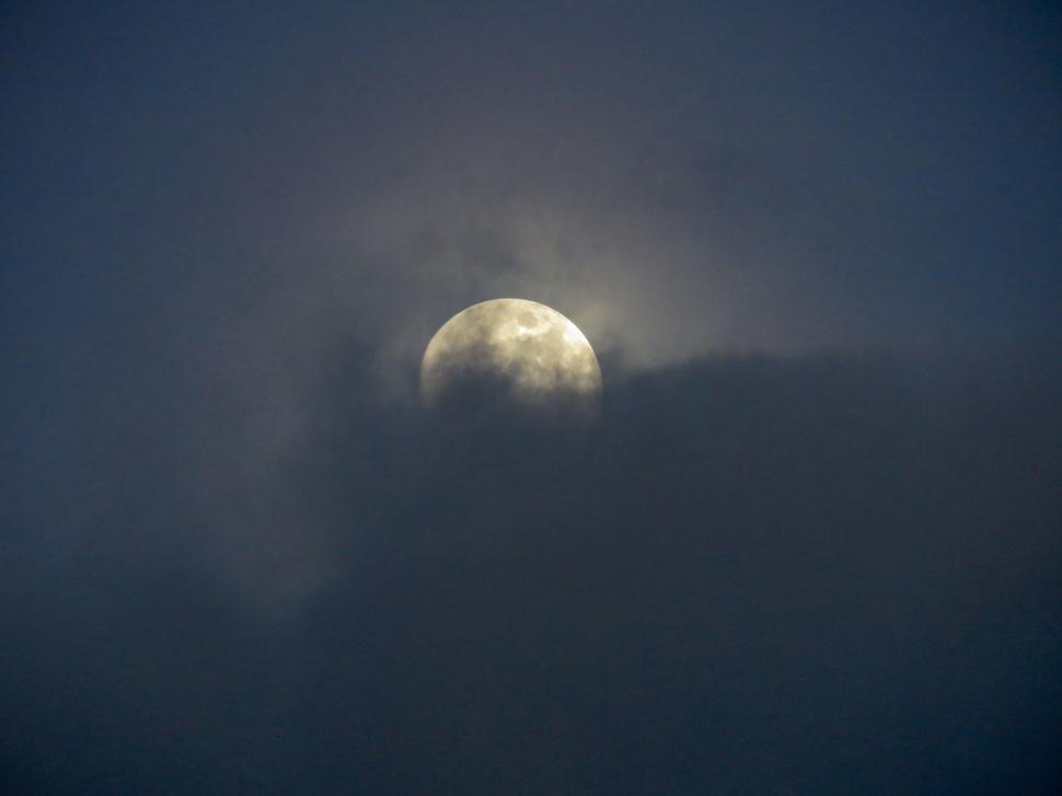Free Image of Full moon partially obscured by clouds 