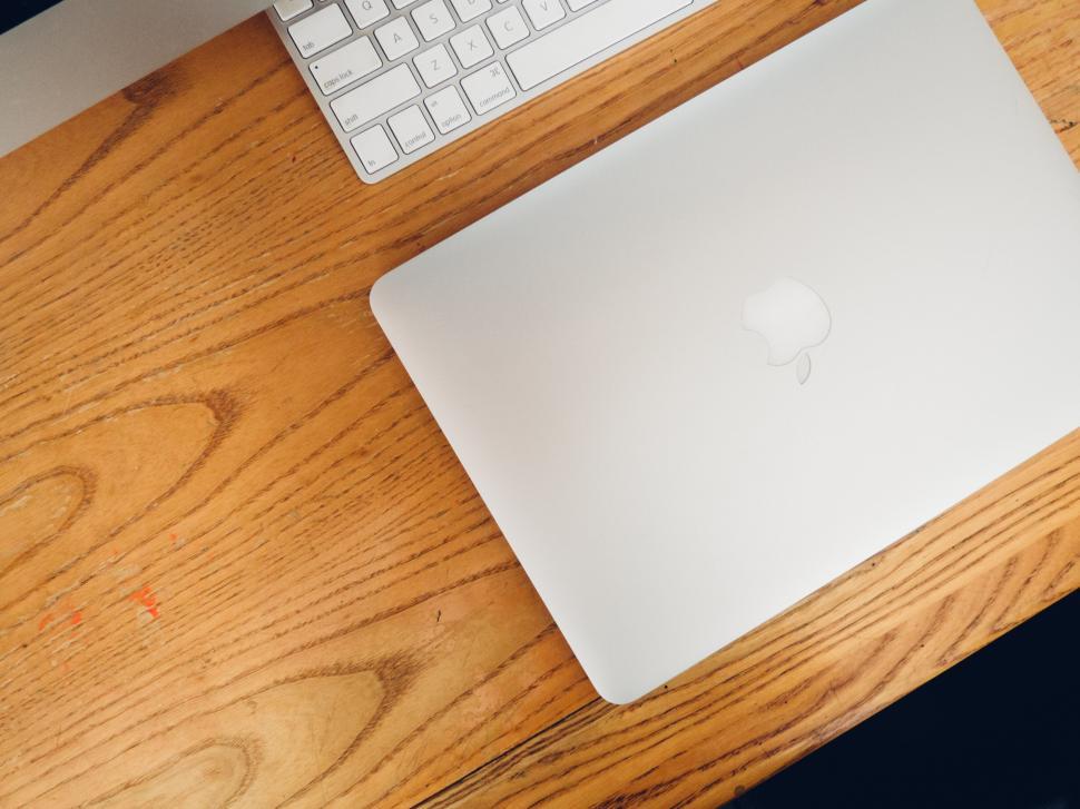 Free Image of Laptop on wooden desk with a keyboard 