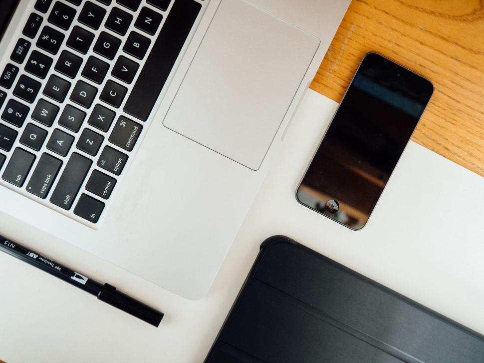 Free Image of Laptop and smartphone on a wooden desk 