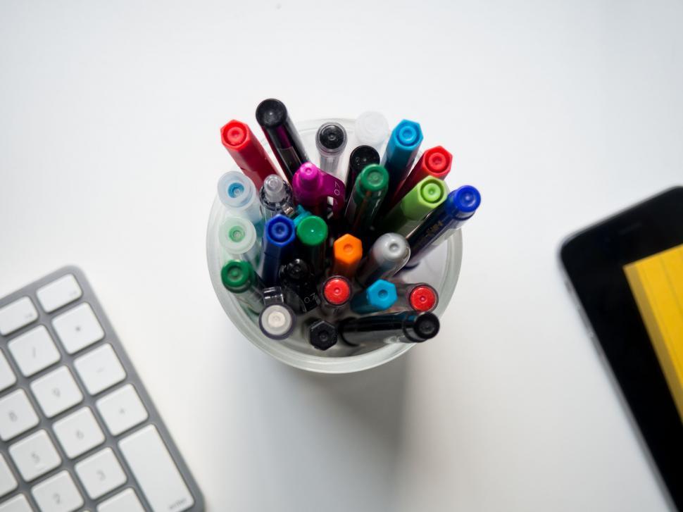 Free Image of Multicolored markers in a white cup 