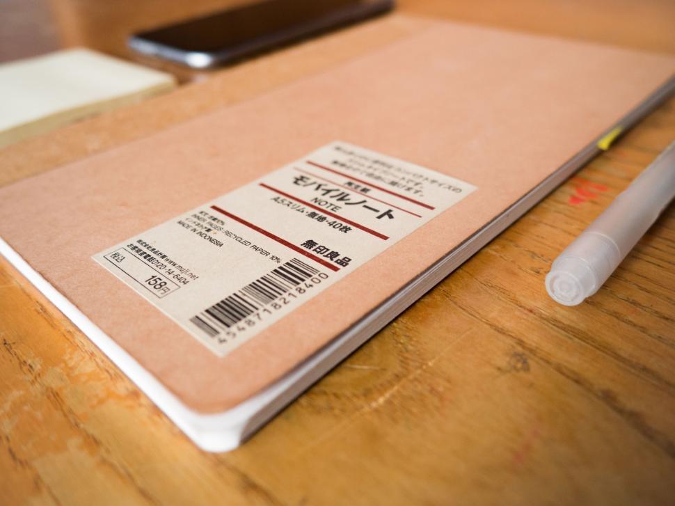 Free Image of Notebook and pen on a wooden desk 