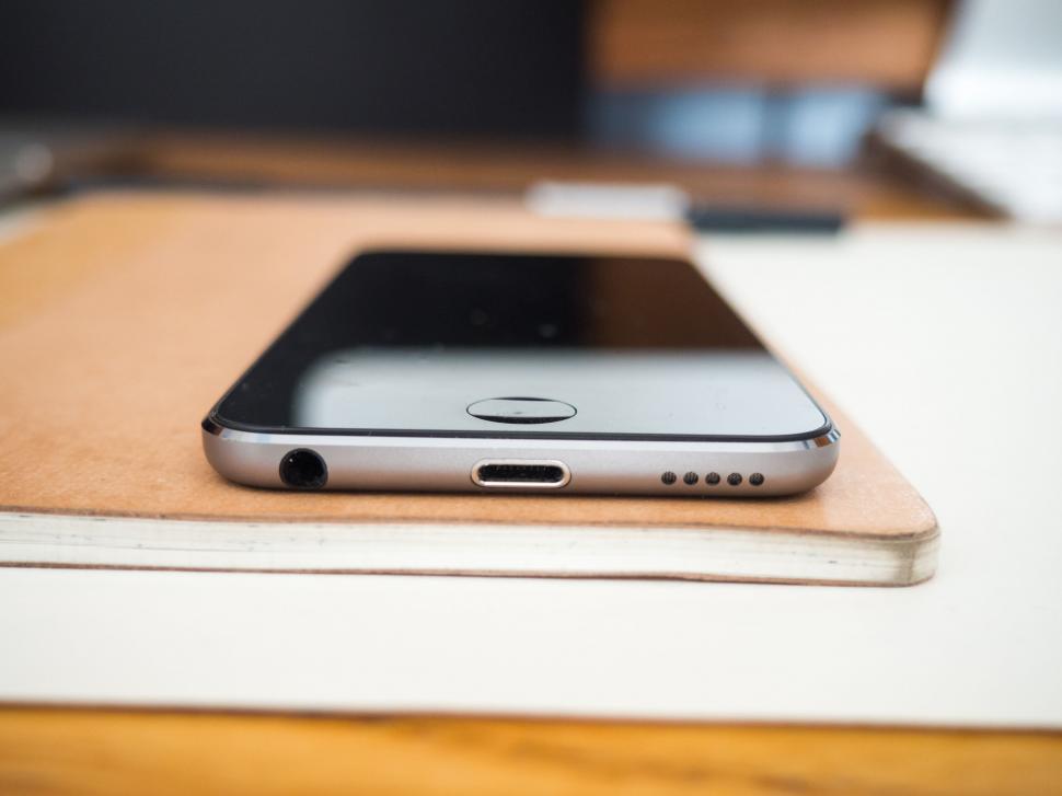 Free Image of Smartphone on a notebook in office setup 