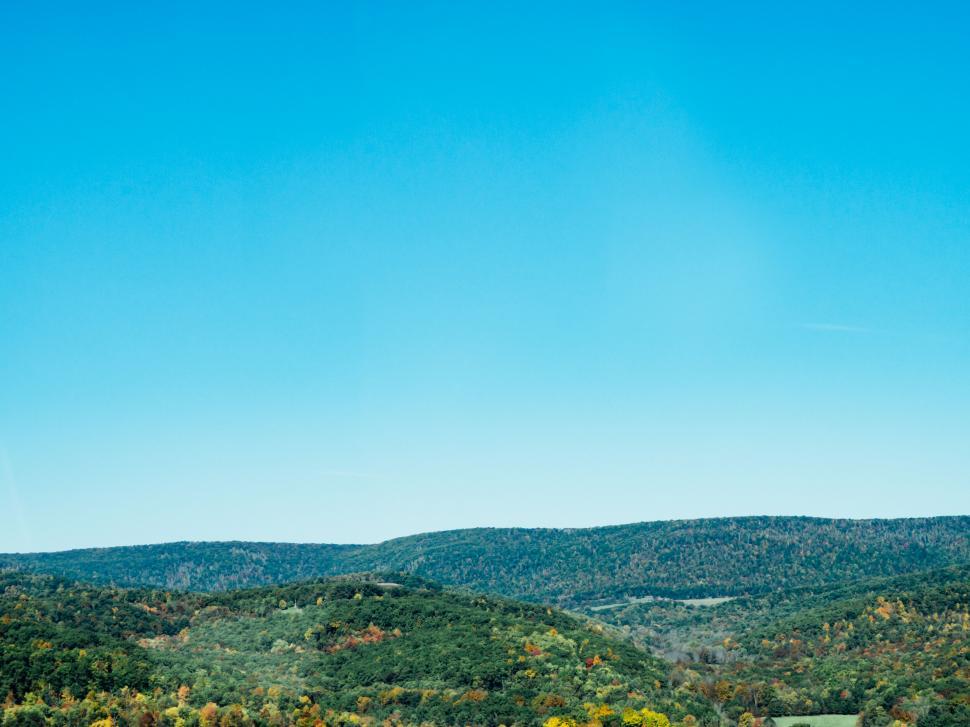 Free Image of Autumn foliage over mountain landscape 
