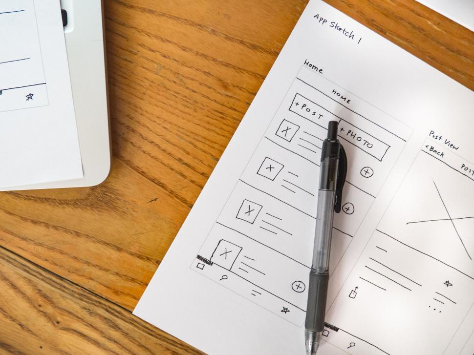 Free Image of Mobile app wireframe on paper with pen 
