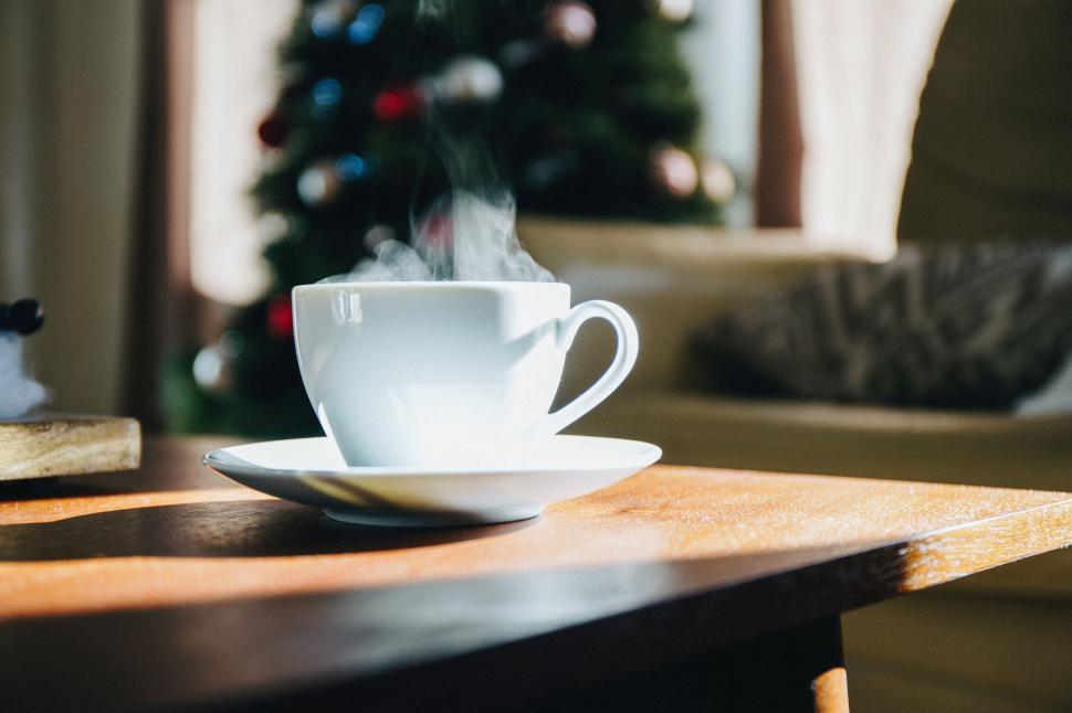 Free Image of Steaming cup of coffee on wooden table 