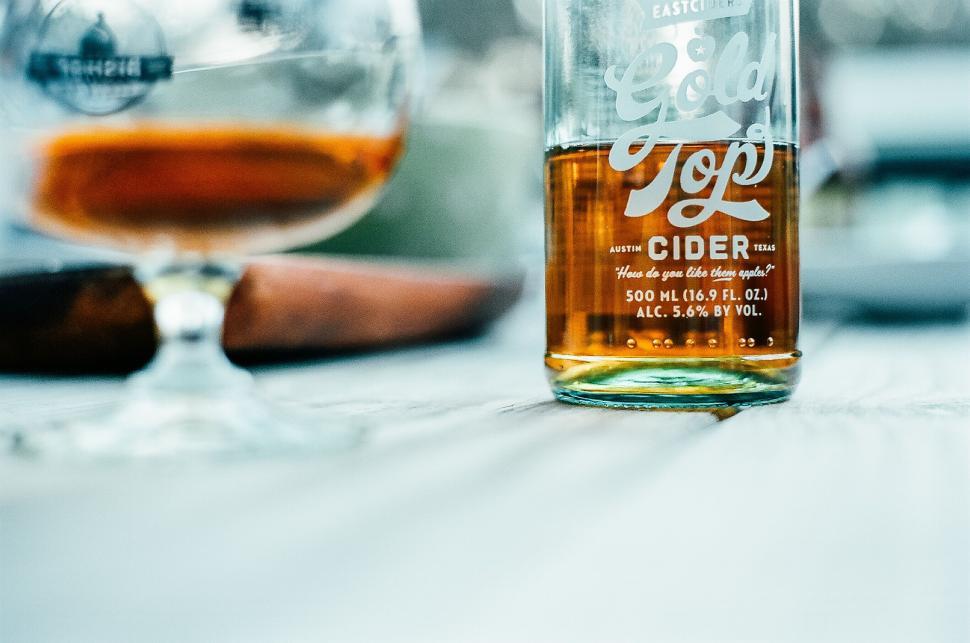 Free Image of Half-empty cider bottle on a table 