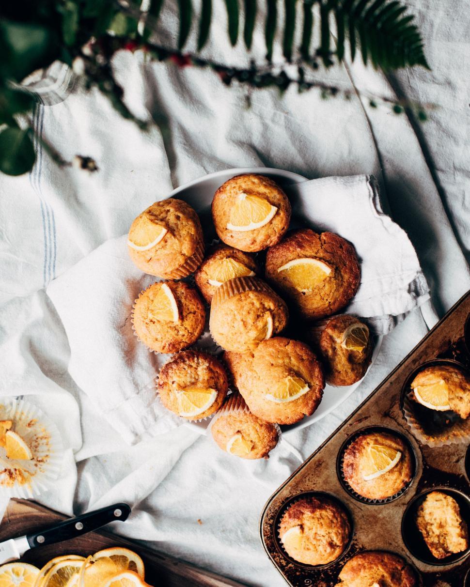 Free Image of Muffins with orange wedges on top 