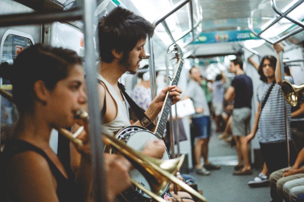 Free Image of Musicians playing instruments in a subway train 