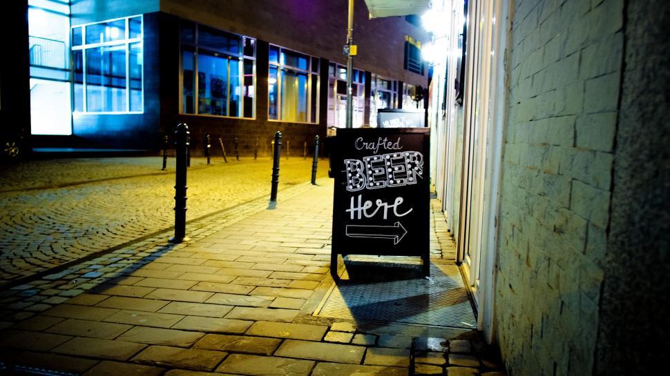 Free Image of Nighttime alley with chalkboard sign 