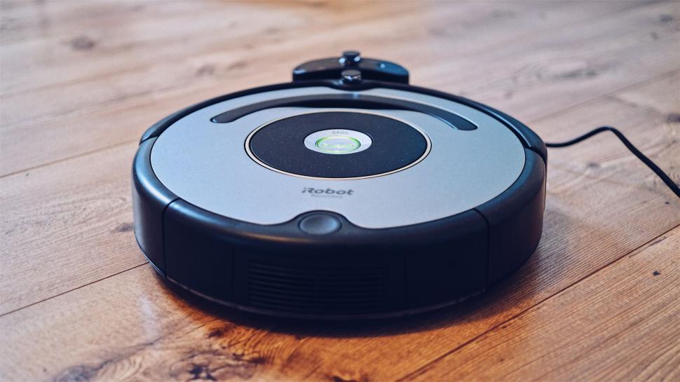 Free Image of Robotic vacuum cleaner on wooden floor 