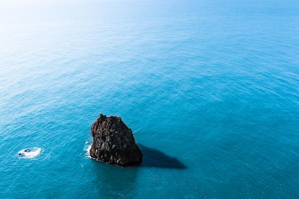 Free Image of Isolated rock formation in blue sea 
