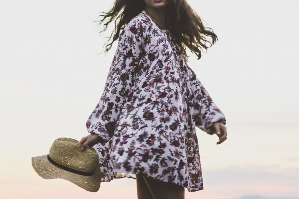 Free Image of Woman in a flowery dress with a hat 