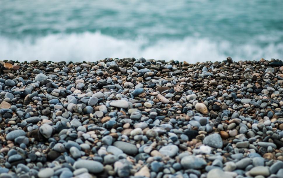 Free Image of Pebble beach with ocean in the background 