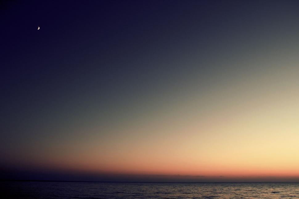 Free Image of Crescent moon in a twilight sky 