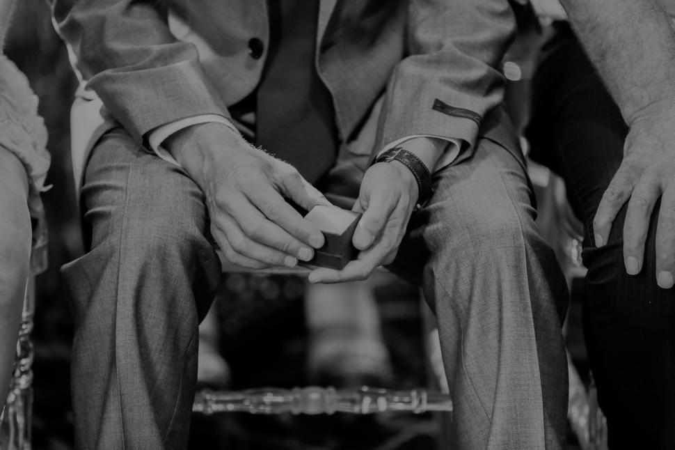 Free Image of Man with crossed hands holding a card 
