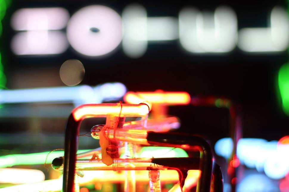 Free Image of Blurry image of neon light sign at night 
