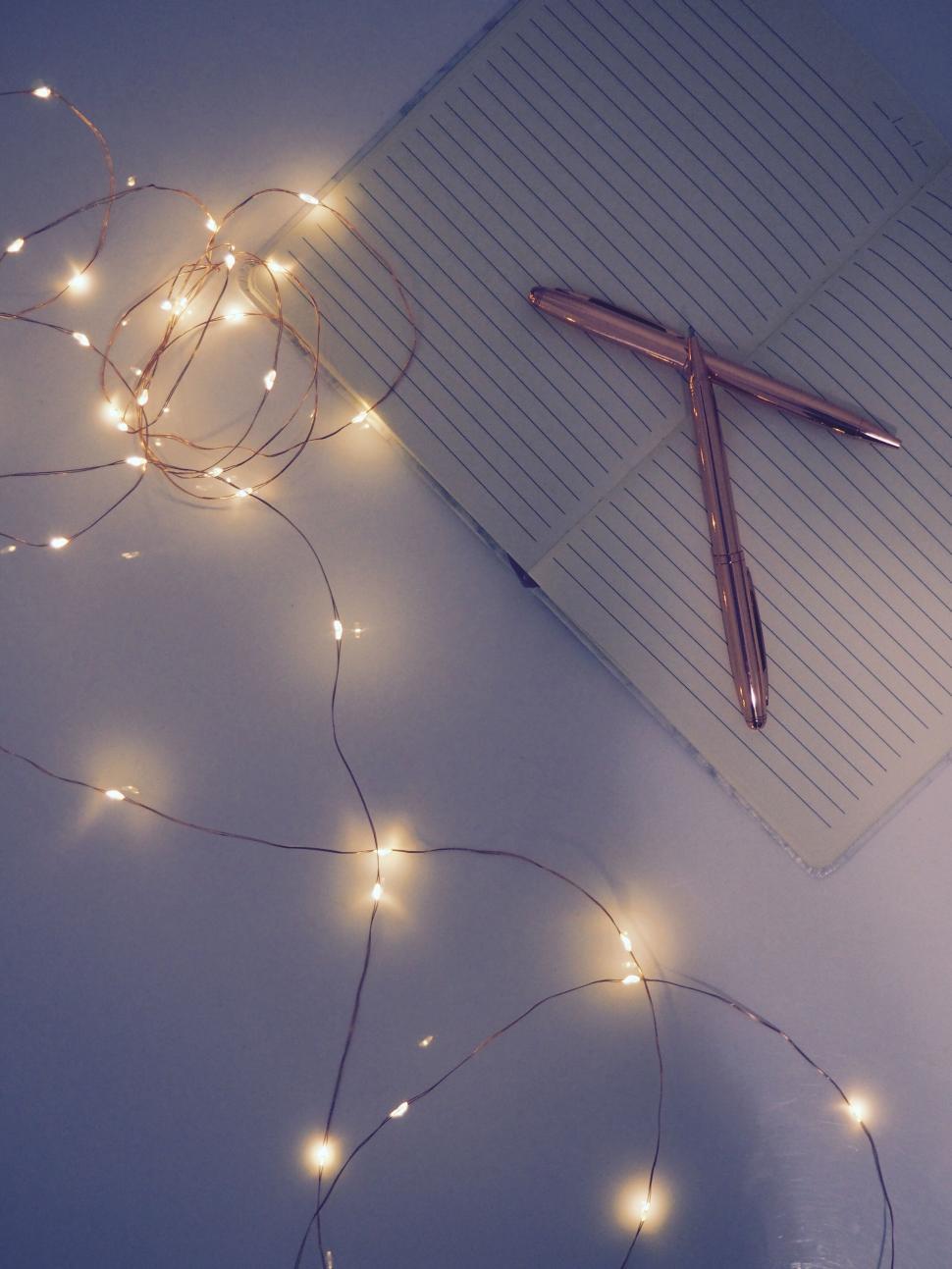 Free Image of Notebook with lights and metallic pen 