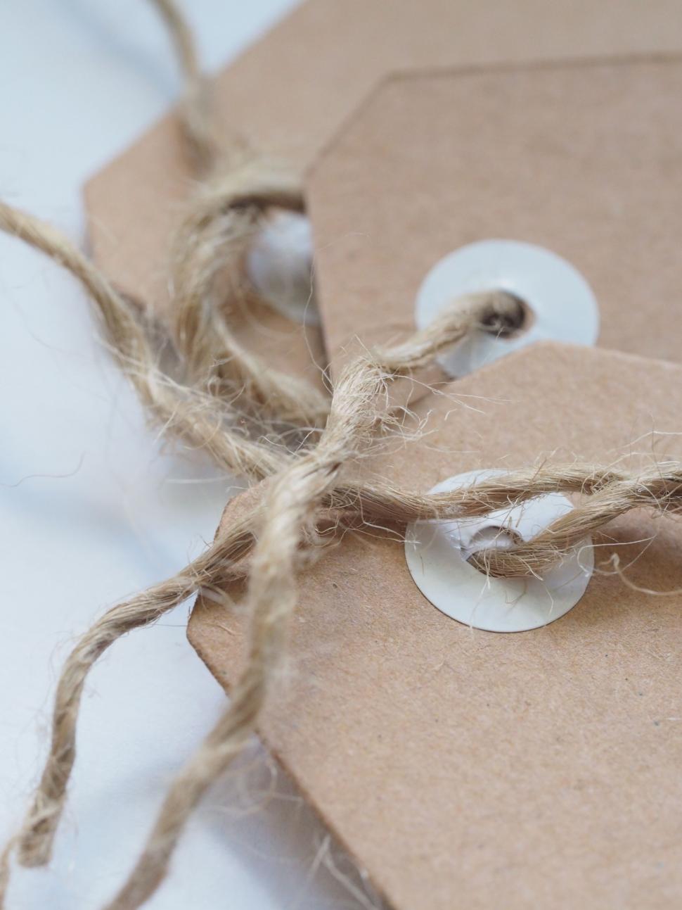 Free Image of Paper tag with string and button 