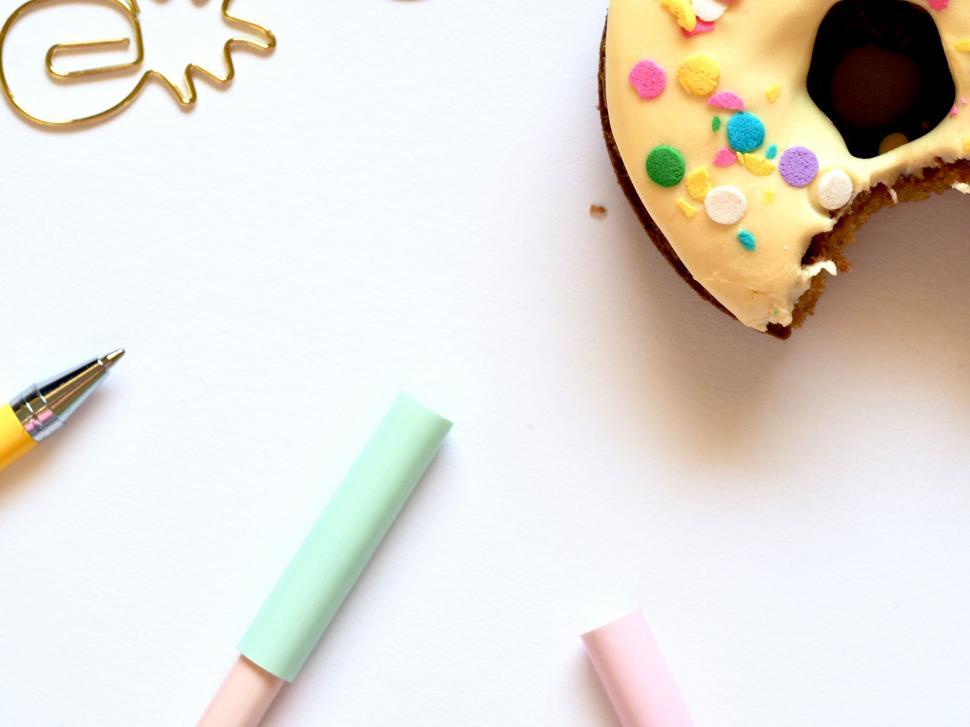 Free Image of Donut and stationery items on white 
