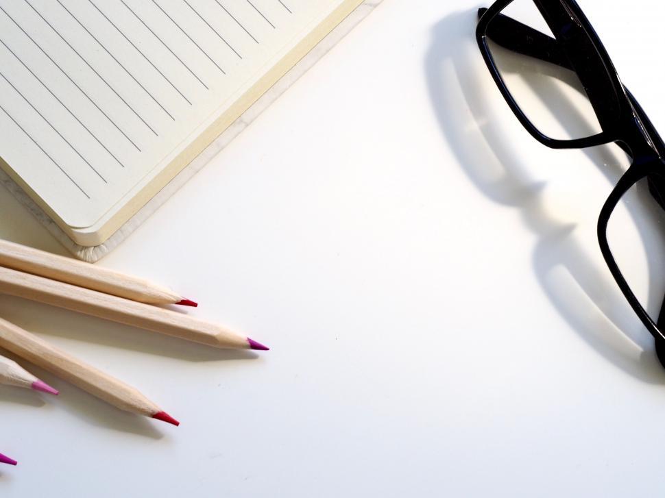 Free Image of Creative workspace with notepad and colored pencils 