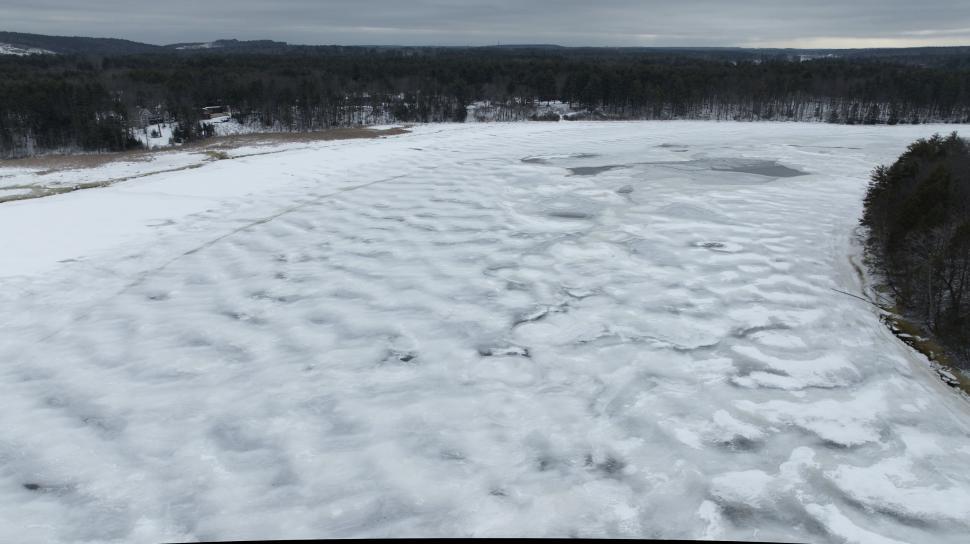 Free Image of Aerial view of icy landscape with trees 