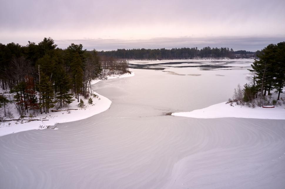 Free Image of Aerial shot of snowy landscape with trees 