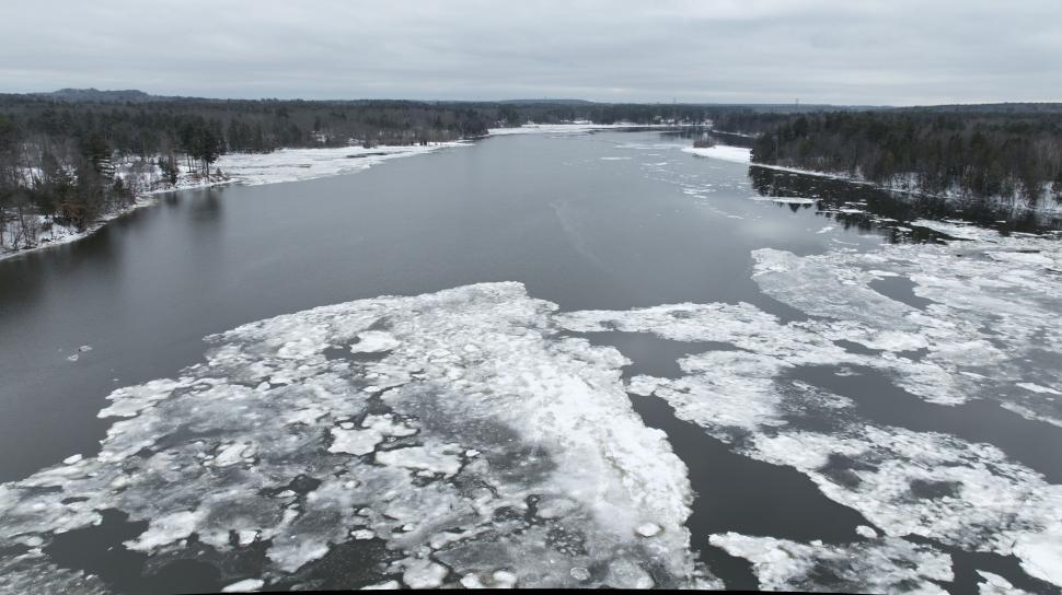 Free Image of Aerial view of a frozen river thawing 