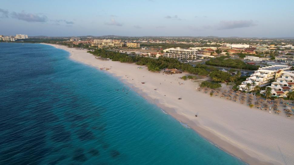 Free Image of Aerial view of sandy beach and coastal city 