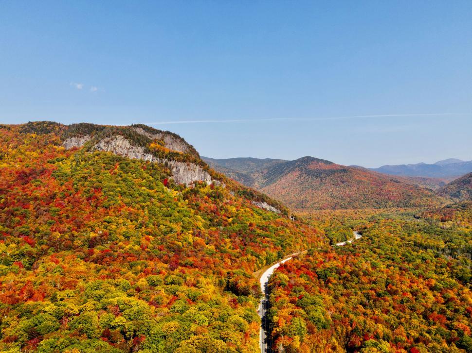 Free Image of Drone shot of autumn foliage in mountain range 