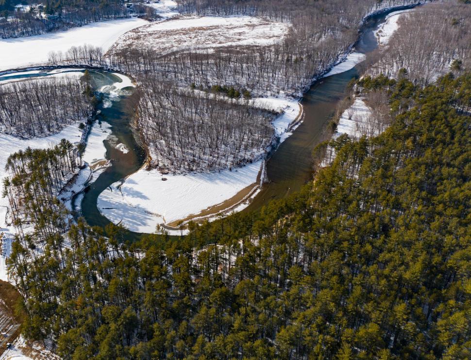 Free Image of Winter river landscape with snow-covered banks 