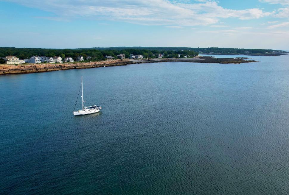 Free Image of Sailboat Near Rocky Coastline 