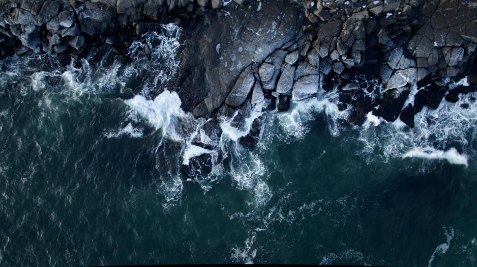 Free Image of Rocky coastline with crashing waves aerial 