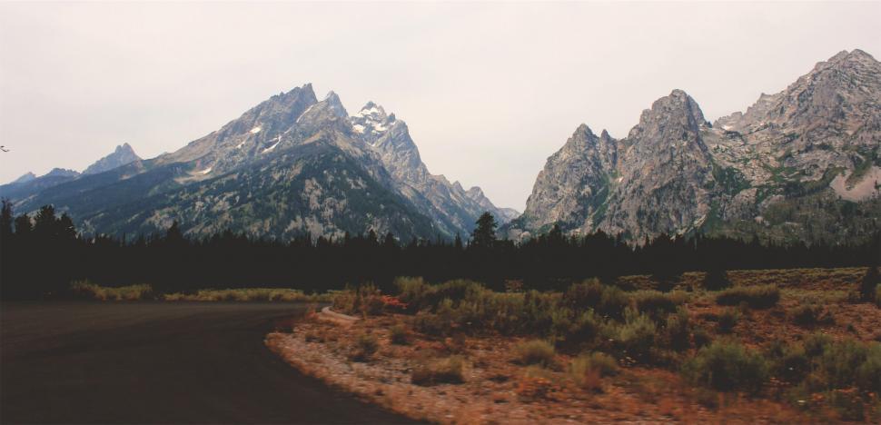 Free Image of Snow-capped mountain peaks and road 