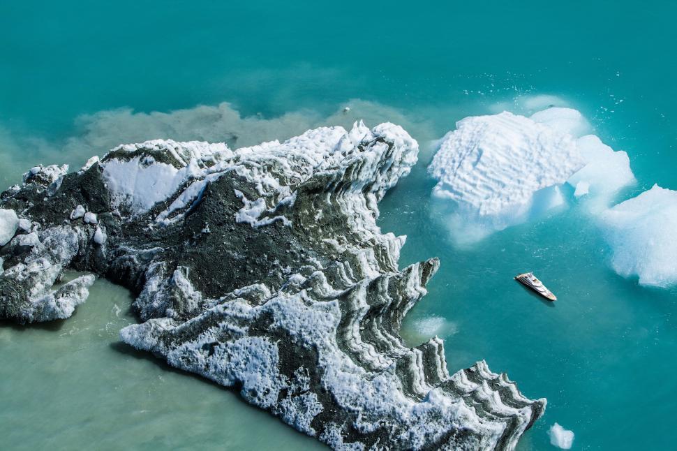 Free Image of Aerial shot of a boat navigating icy waters 