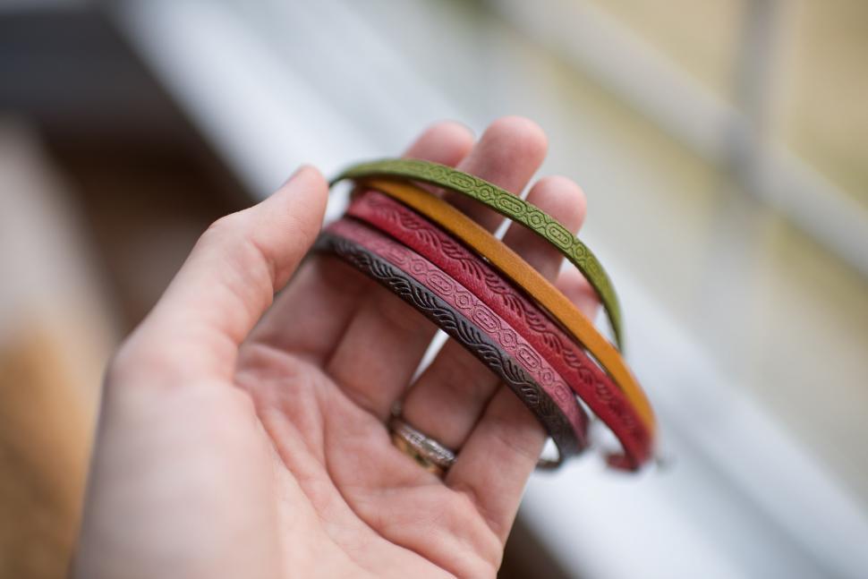 Free Image of Colorful leather bracelets held in hand 