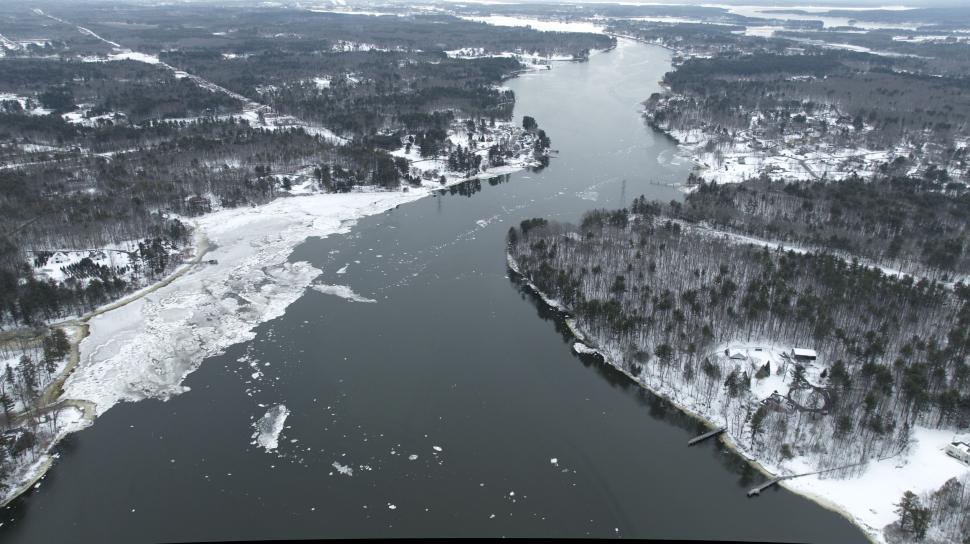Free Image of Frozen river winding through snow-covered landscape. 