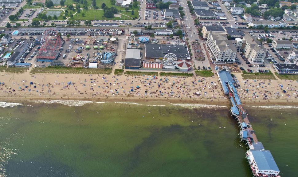 Free Image of Aerial view of a bustling beach and amusement park. 