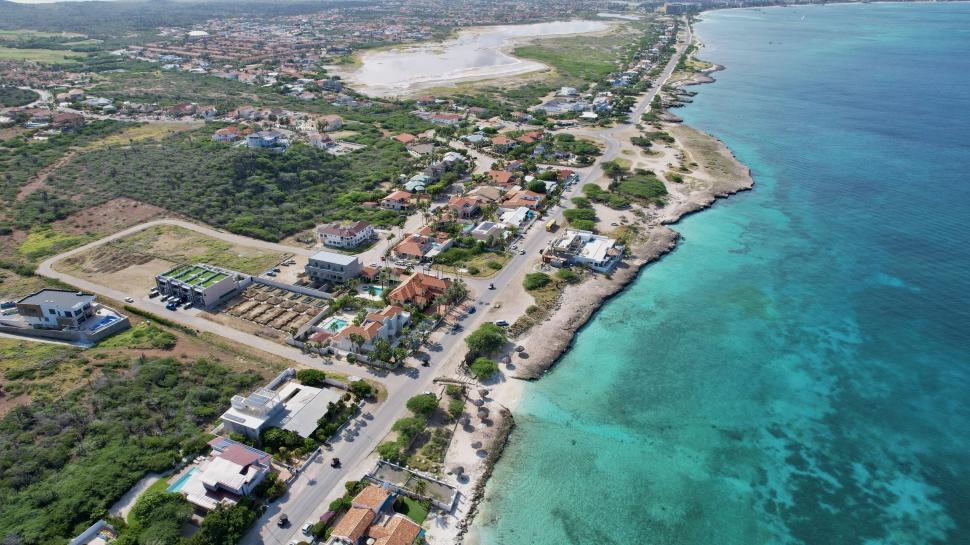 Free Image of Aerial view of coastal town with turquoise ocean water. 
