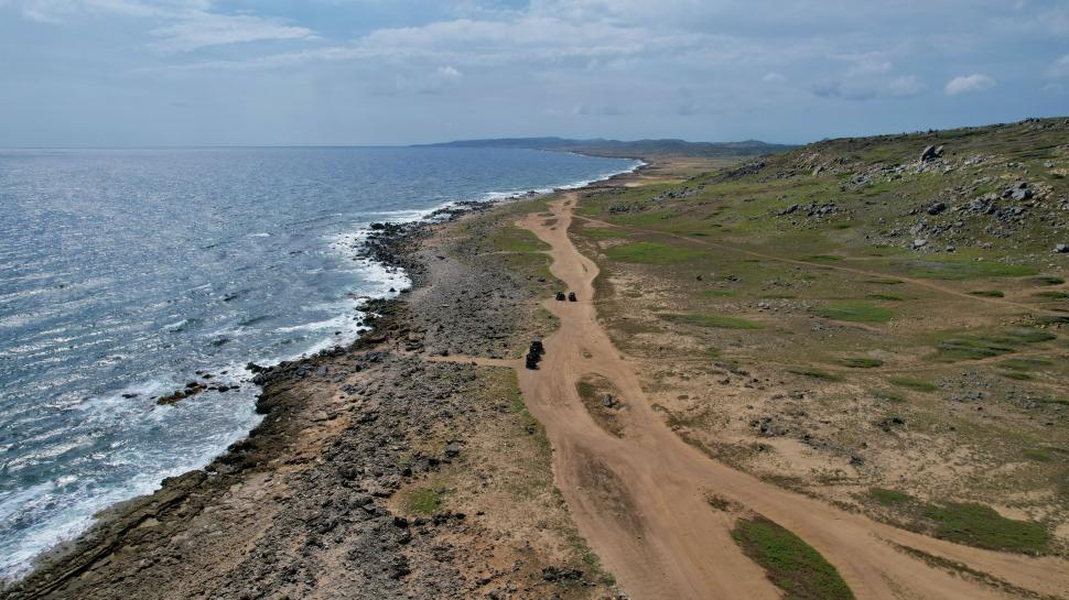 Free Image of Coastal landscape with rocky shore and dirt path 
