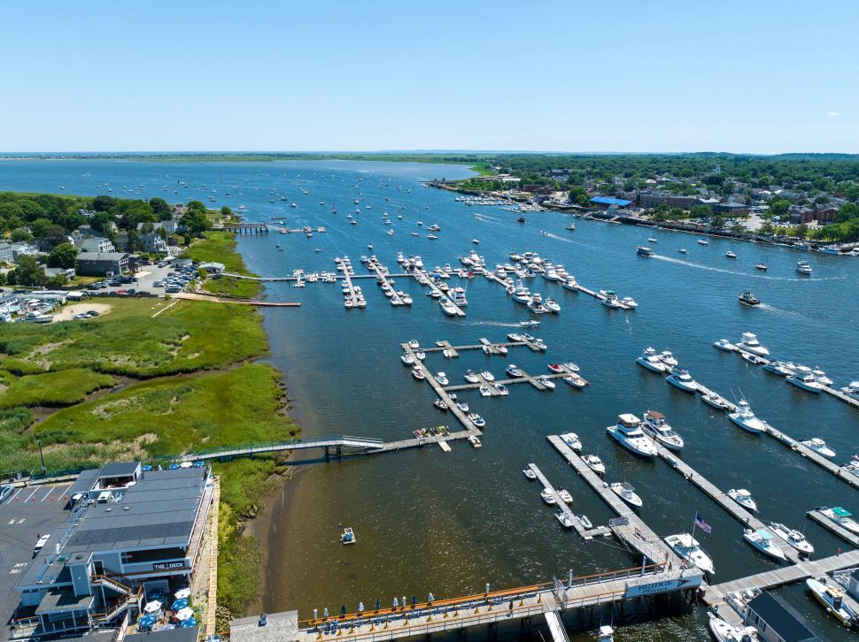Free Image of Boats anchored in a calm bay with clear blue sky above 