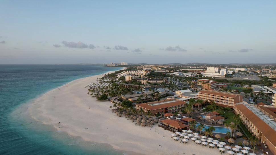 Free Image of Beachfront resort with sprawling sandy shores and pools 