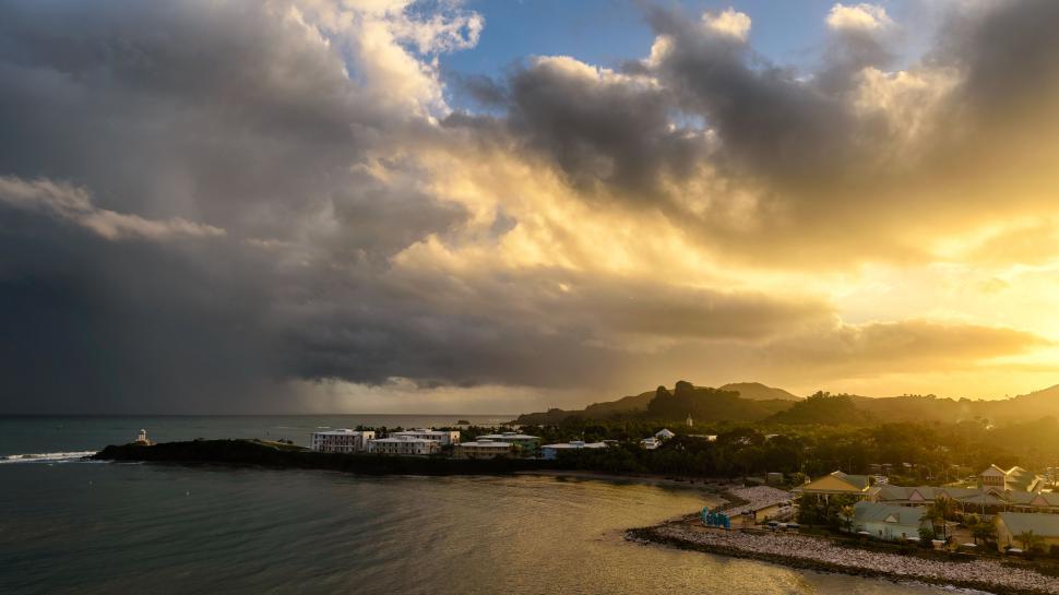 Free Image of Coastal landscape with golden sunset and clouds 