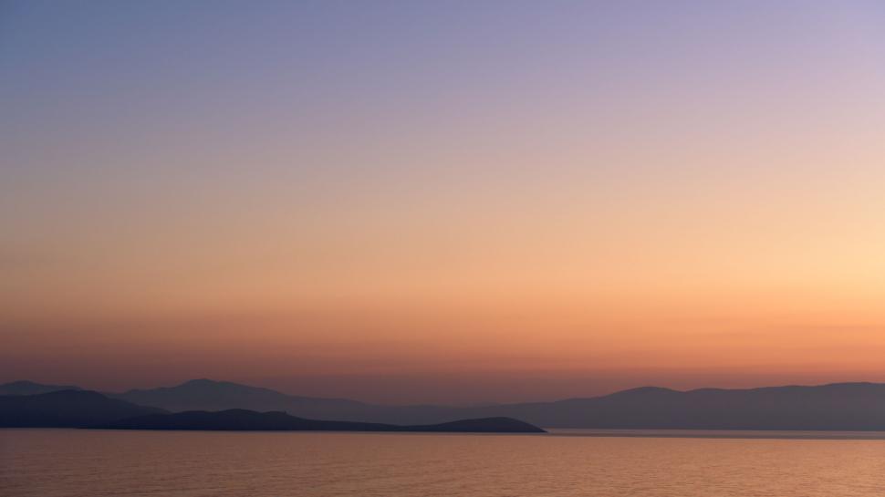 Free Image of Serene landscape view of a sunset over calm waters 