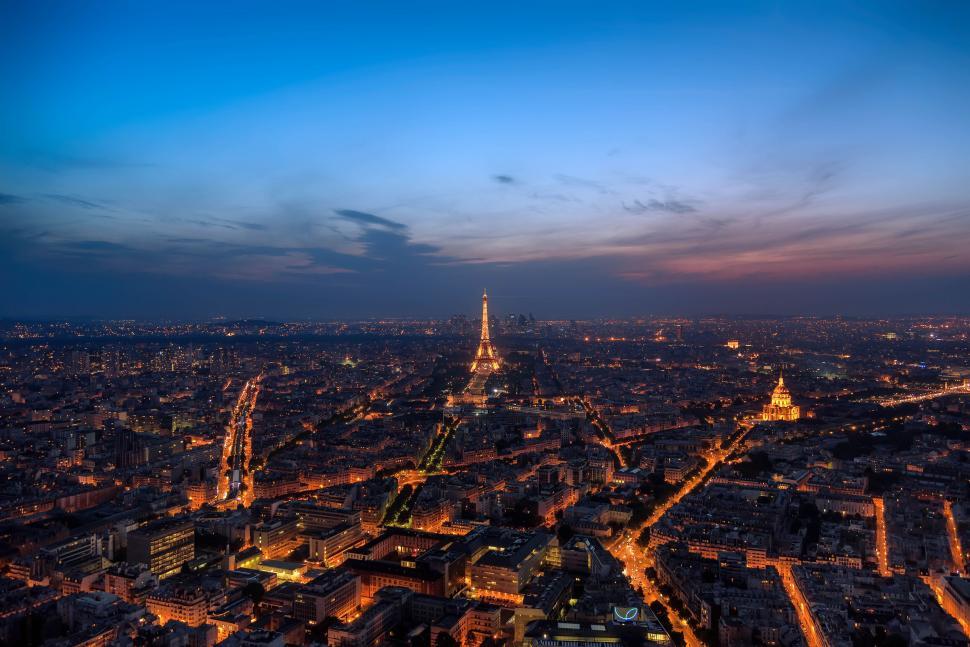 Free Image of Aerial view of illuminated city with a prominent tower. 