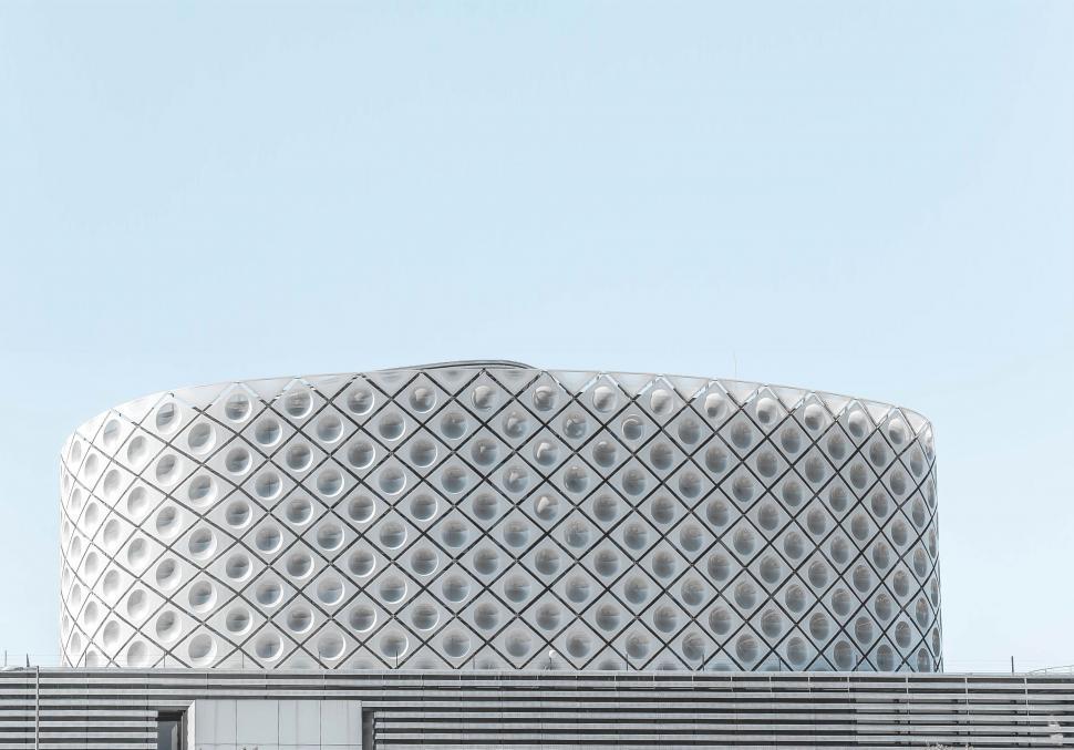 Free Image of Futuristic oval building facade with geometric patterns 