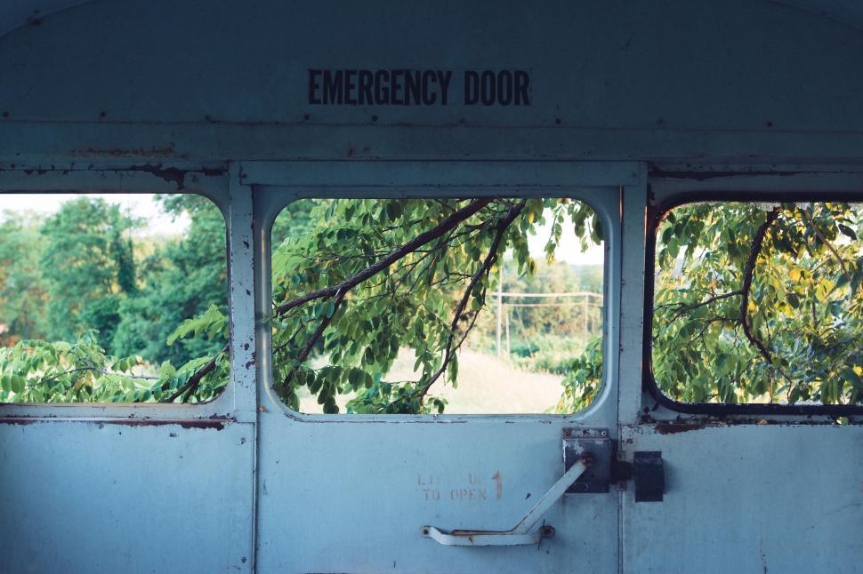 Free Image of Old bus emergency door with nature in background 