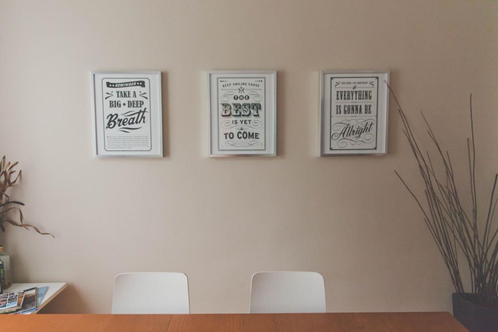 Free Image of Minimalistic room with inspirational framed quotes. 