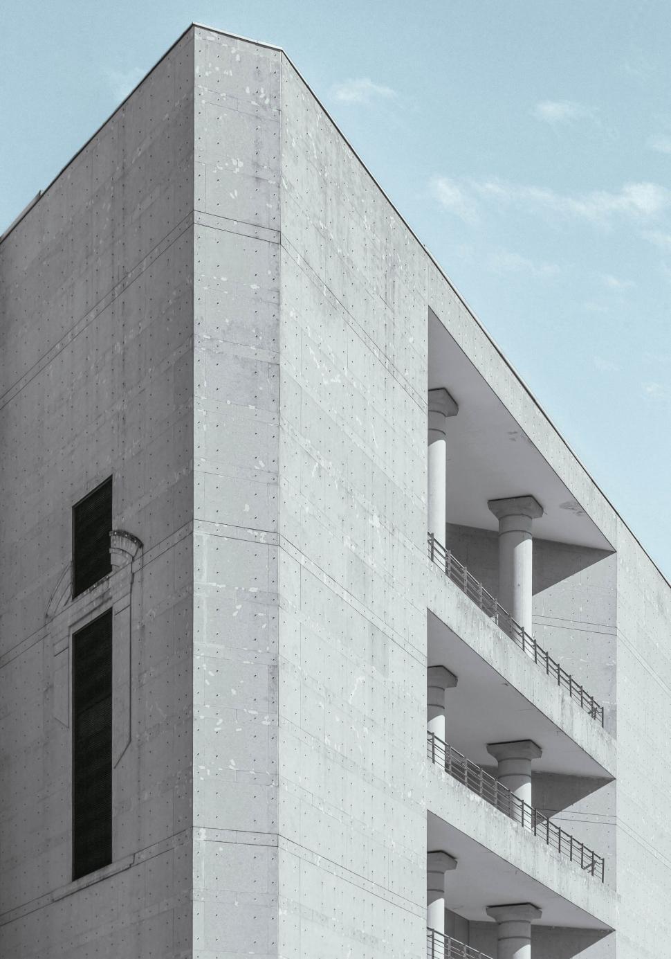 Free Image of Minimalist concrete building with balconies and pillars 