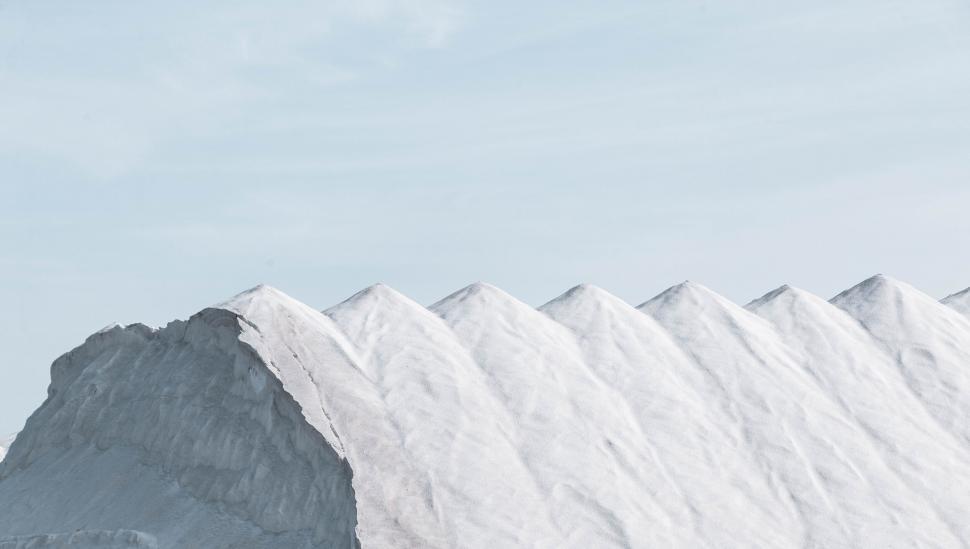 Free Image of Snow-covered mountain peaks under a clear blue sky 